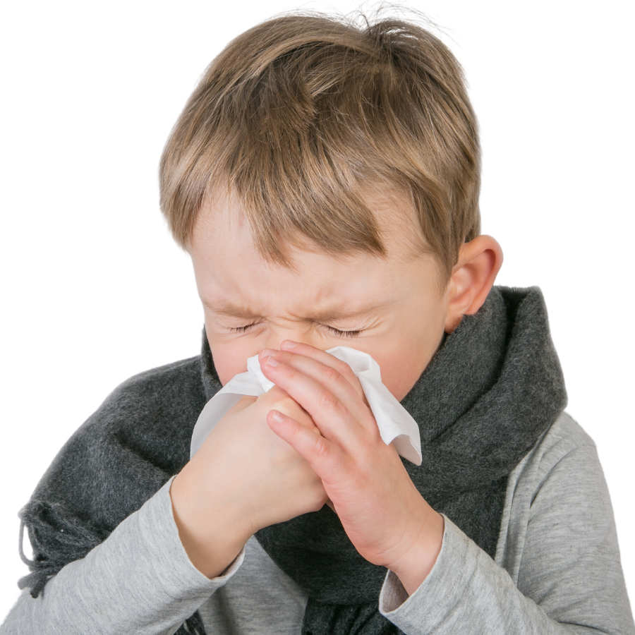 young boy blowing his nose